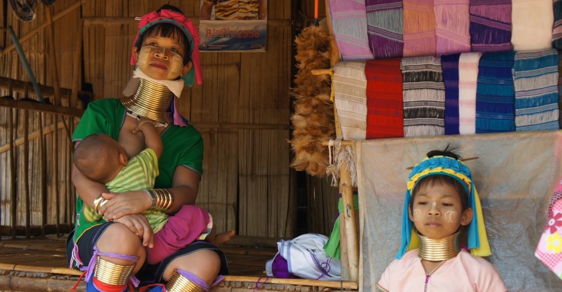 A Kayan mother with her baby and a young girl in northern Thailand